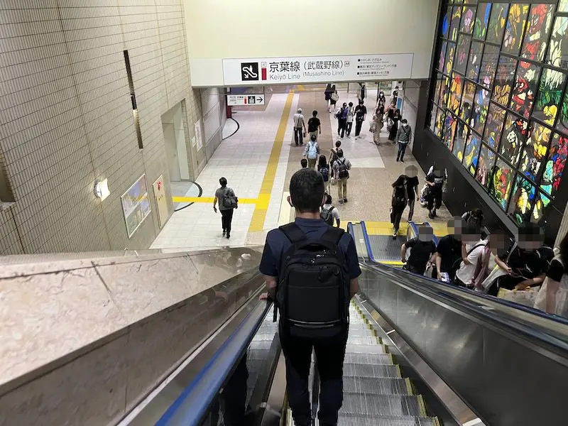 Escalator going down to B2F. The opening on the left is the elevator connecting B1 and B2 floors.
