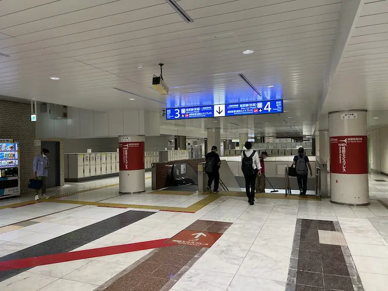 Go down the escalator and make a U-turn to the left and you will see coin lockers.
