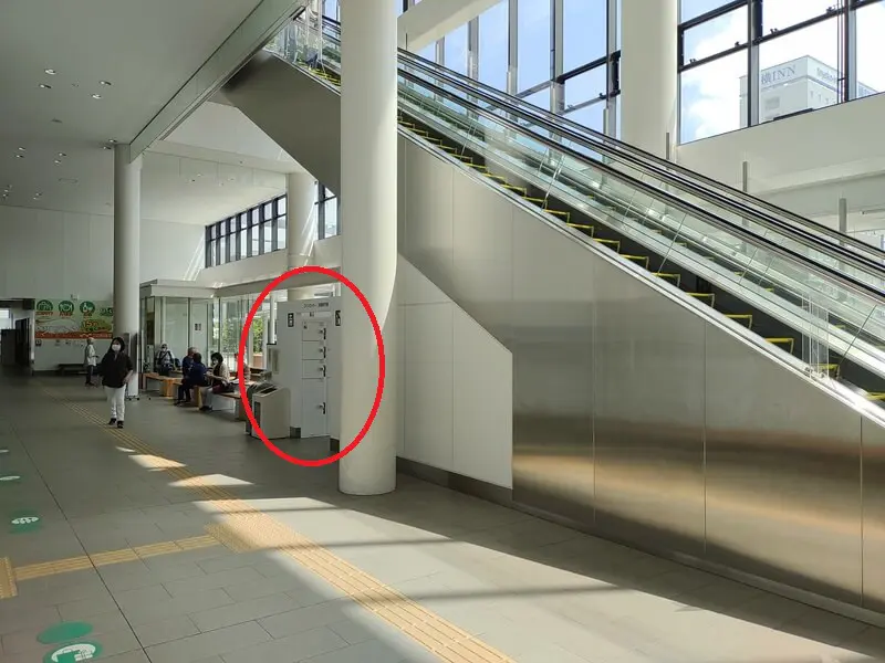 When you get off the elevator and turn left, you will see a coin locker storage area at the bottom of the escalator.
