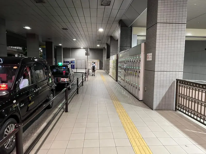 Go down the escalator and to the right, there are coin lockers along the roundabout.