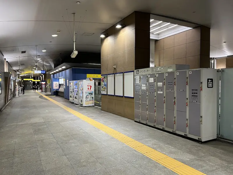 The ticket gate is at the back of the ticket office.