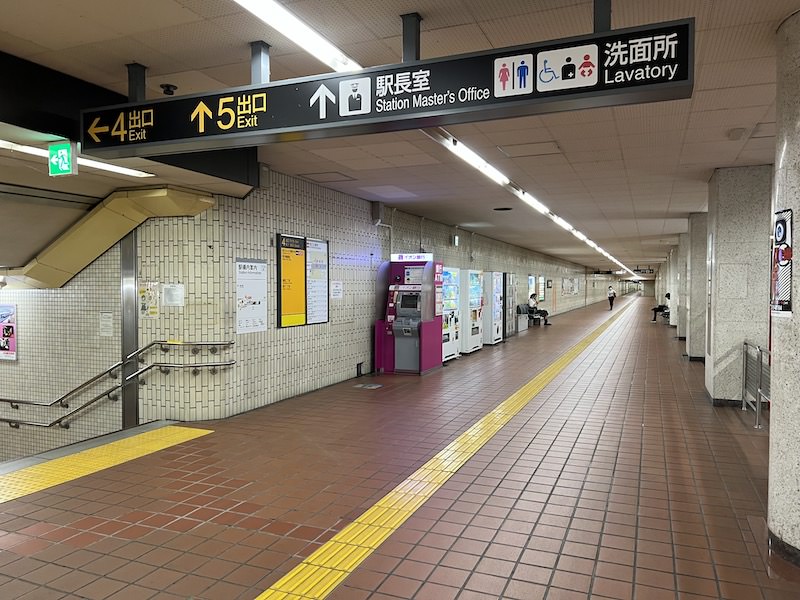 5出入口へ向かう通路内、飲料水の自動販売機の奥にコインロッカーが見える。
